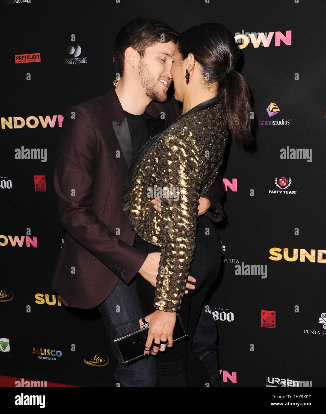 Devon Werkheiser kisses girlfriend Sara Montez as they attend the