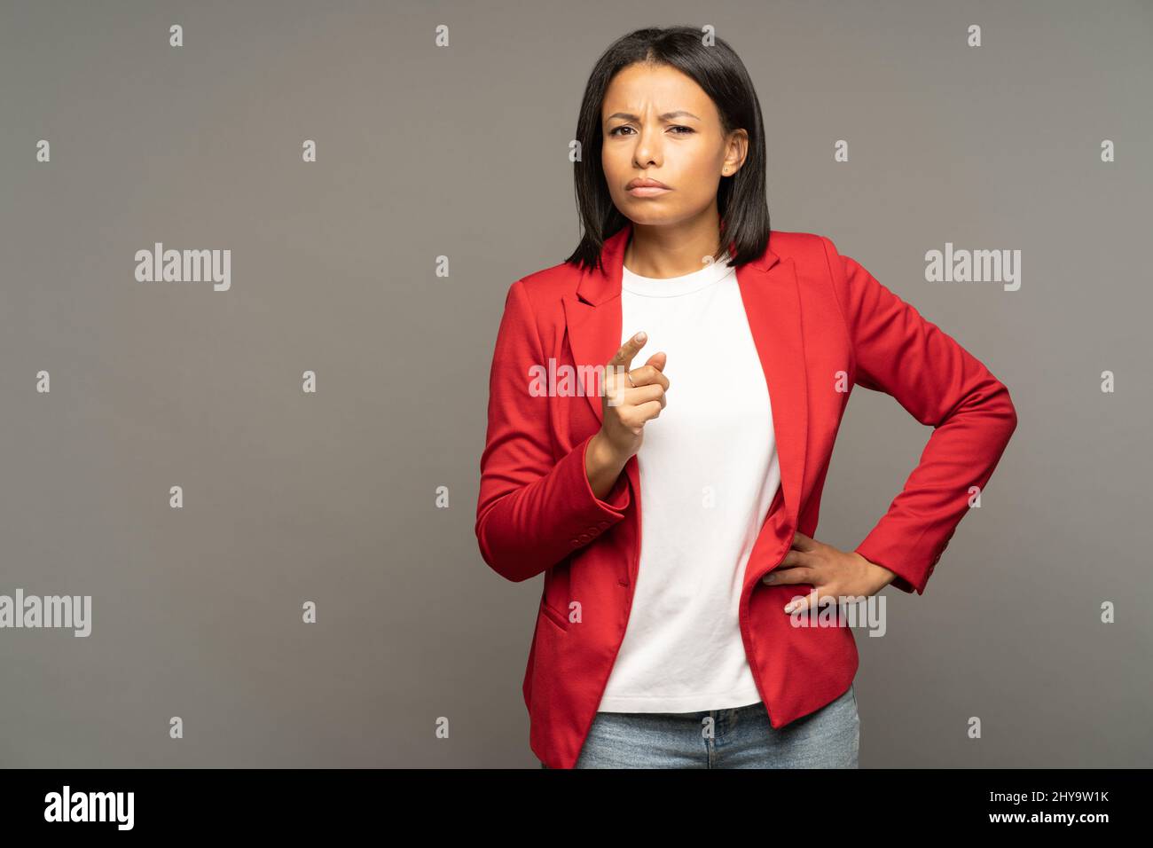 Skeptical thoughtful african american businesswoman pointing finger, looking with doubts in camera Stock Photo