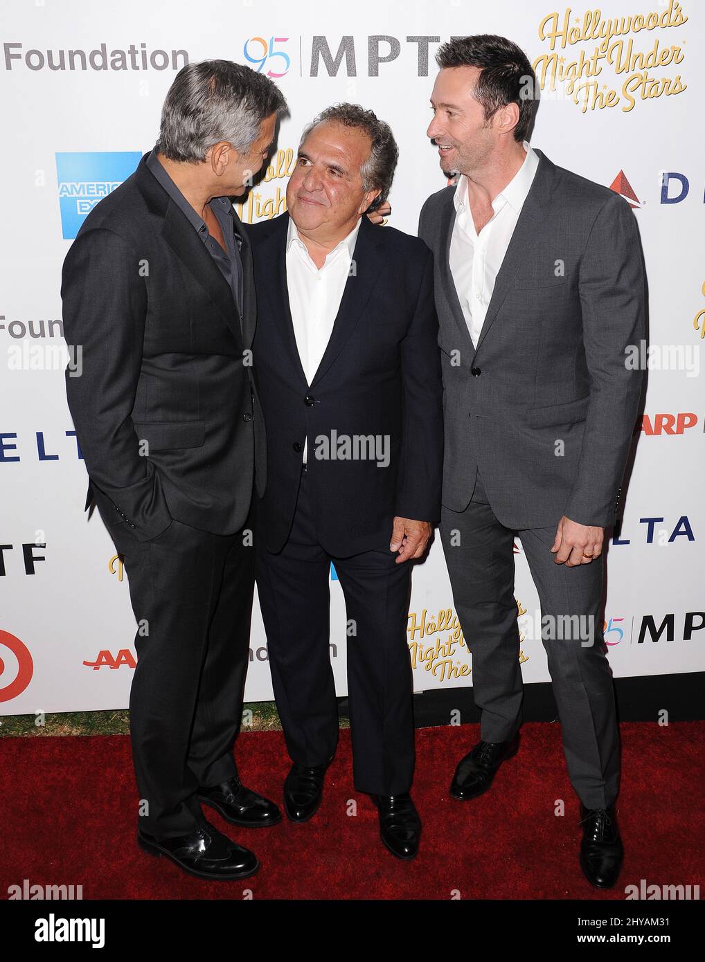 George Clooney, Jim Gianopulos, Hugh Jackman attending the 'Hollywood's Night Under The Stars' 95th Anniversary Celebration held at MPTF Wasserman Campus in Los Angeles, USA. Stock Photo