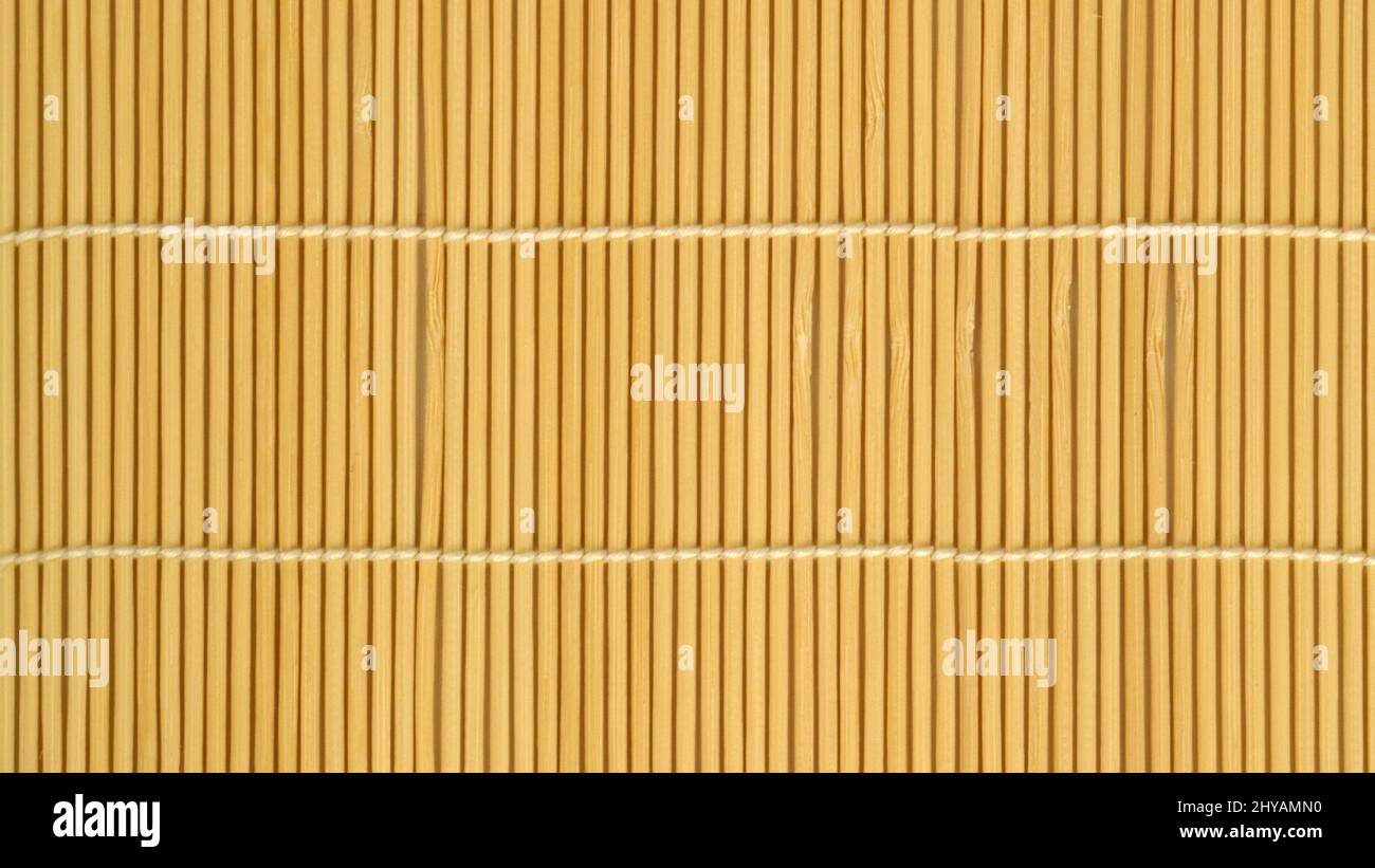 woven texture of light brown bamboo sticks with a vertical arrangement studio photo Stock Photo