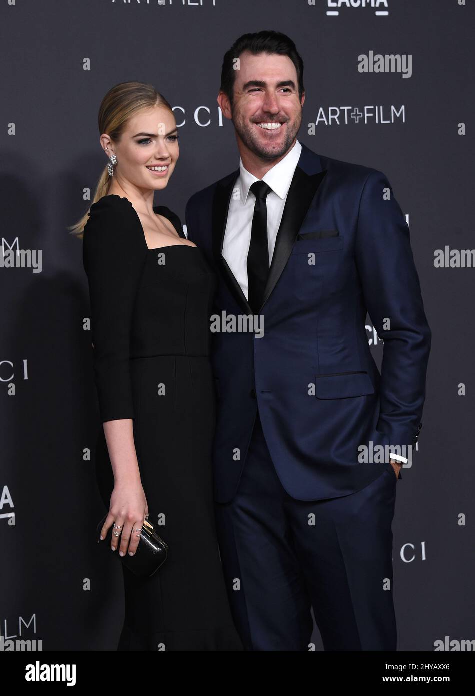 A color, born digital image of Justin Verlander #35 of the Houston Astros  smiling for a photo with his fiancé, American model and actress Kate Upton,  and the game worn jersey that