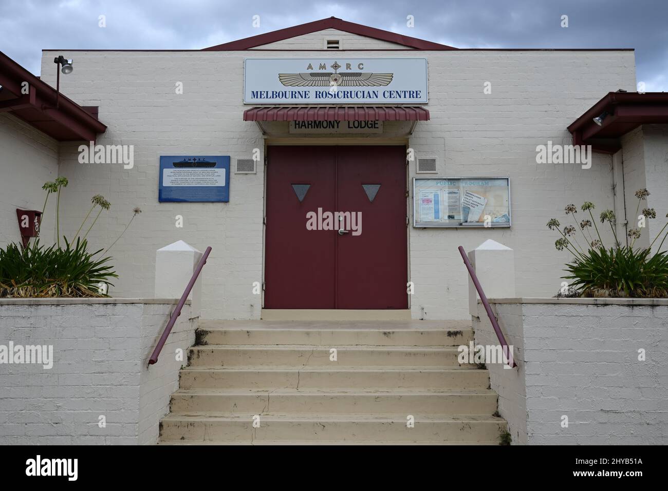 Main entrance to the Melbourne Rosicrucian Centre, or Harmony Lodge, on North Rd, with dark clouds in the background Stock Photo