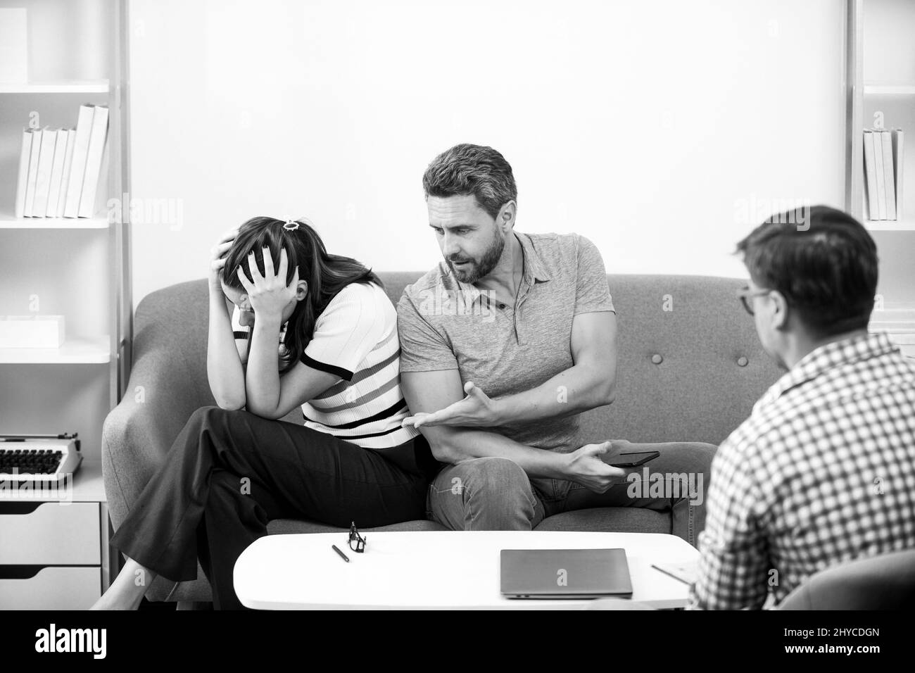 Social worker psychologist talking to young couple. Couple telling the