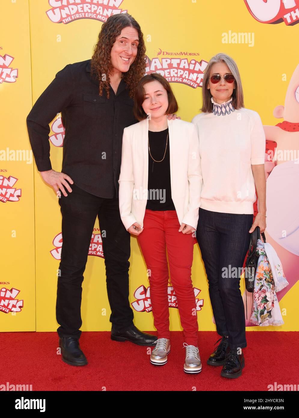 Weird Al Yancovic, Suzanne Krajewski and Nina Yancovic attending the Captain Underpants: The First Epic Movie in Los Angeles Stock Photo