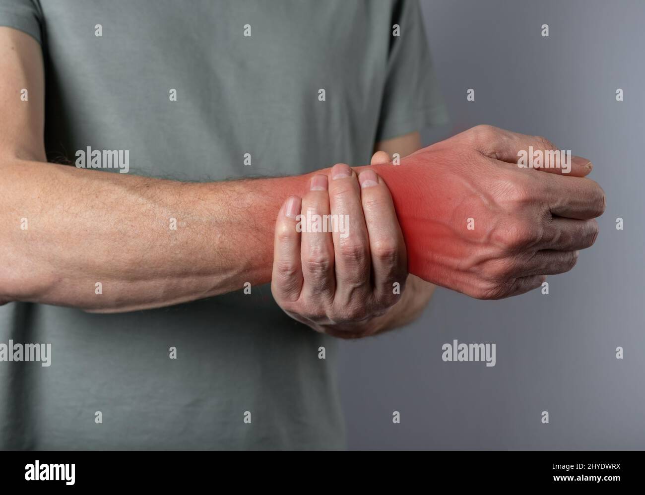Wrist pain. Man hand closeup holding painful wrist. Health care concept