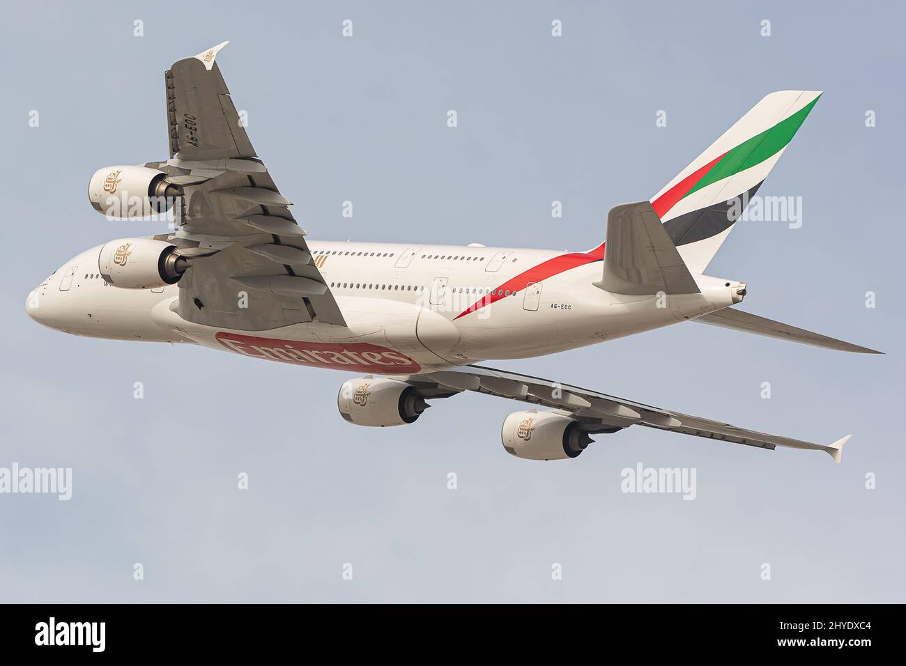 Low-angle shot of an Aibus 380 of Emirates Airline flying against the blue sky Stock Photo