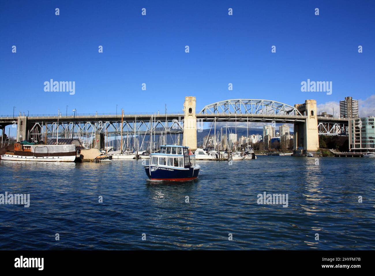 Small boat is crossing False Creek in Vancouver Stock Photo - Alamy