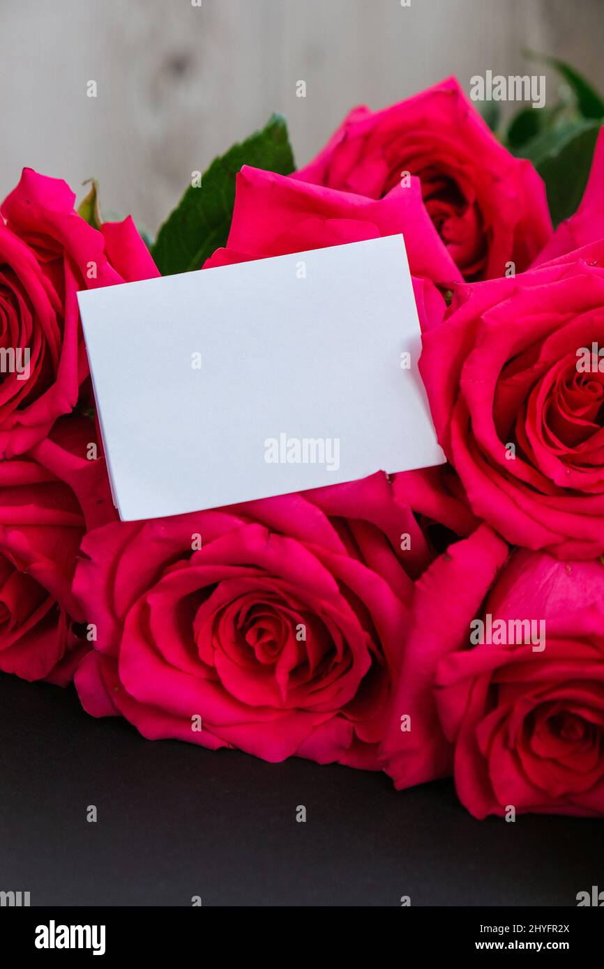 Pink roses and white empty paper note copy space for text. Holiday Mock ...