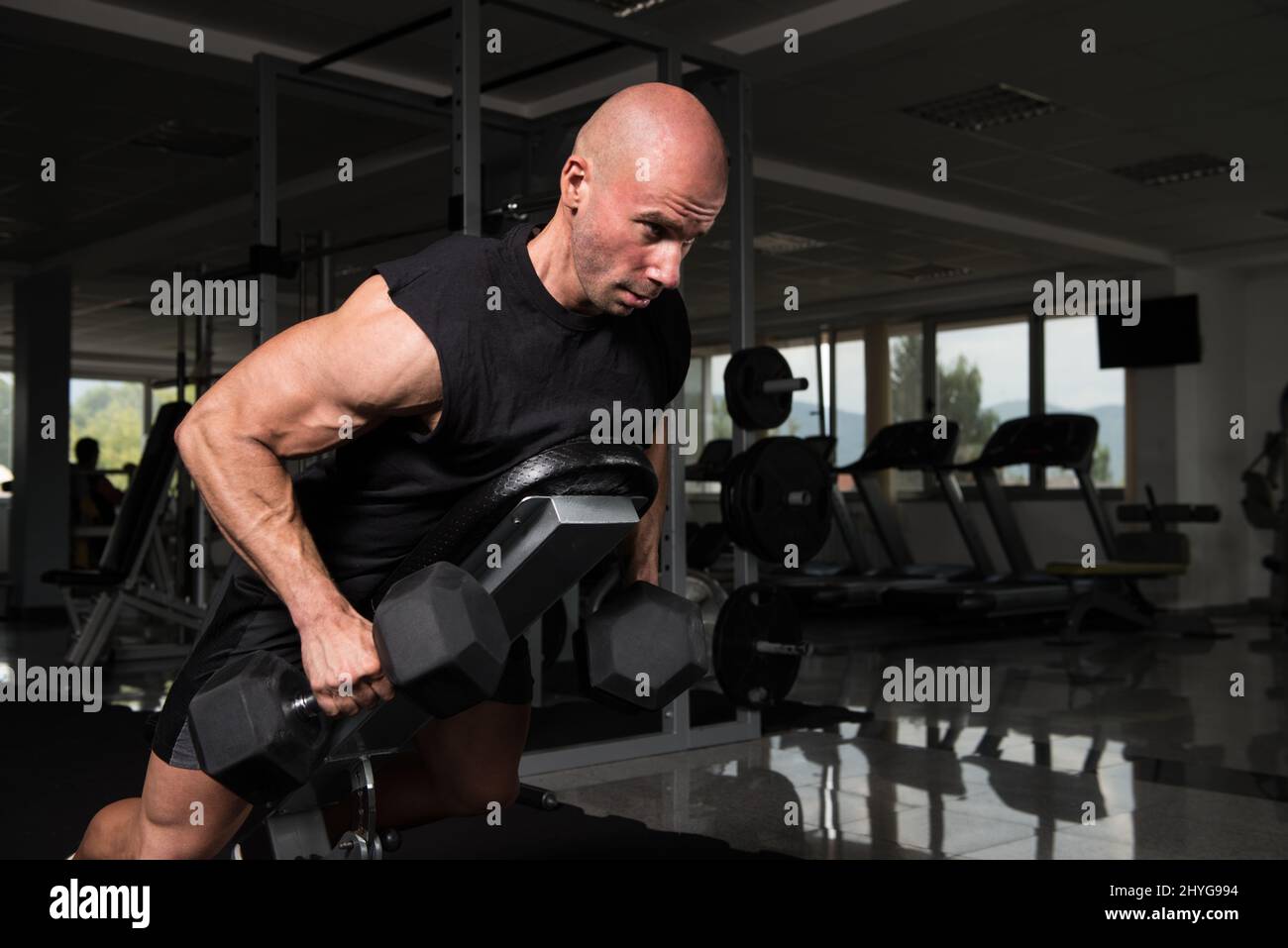 Serious Bodybuilder Doing Heavy Weight Exercise For Trapezius or Back