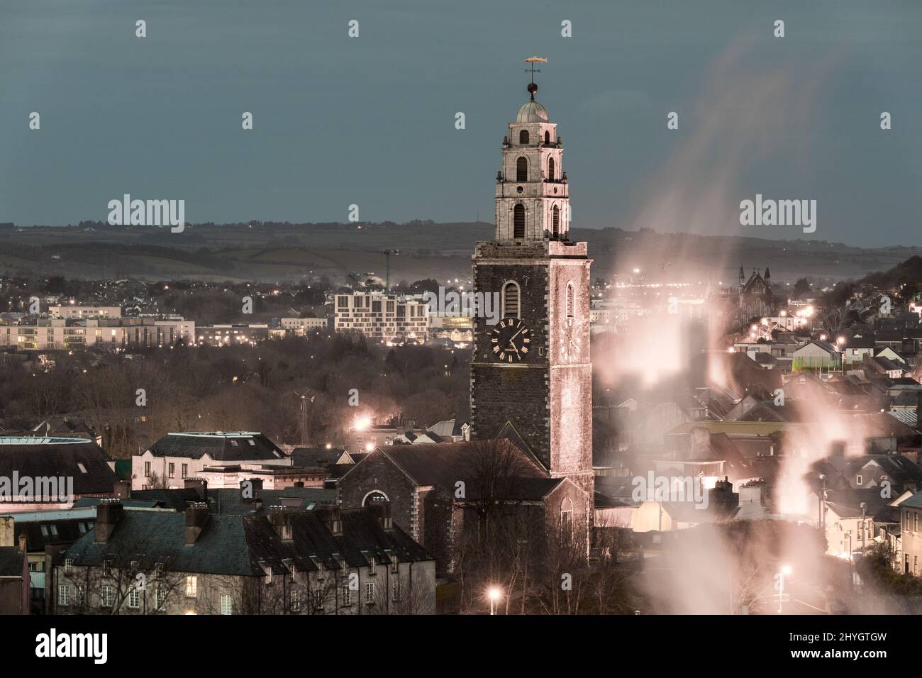 Cork City, Cork, Ireland. 15th March, 2022. The tower of St Anne's Church, Shandon rises above the streets of terraced houses on a cold morning,  Cork Ireland.  - Credit; David Creedon / Alamy Live News Stock Photo