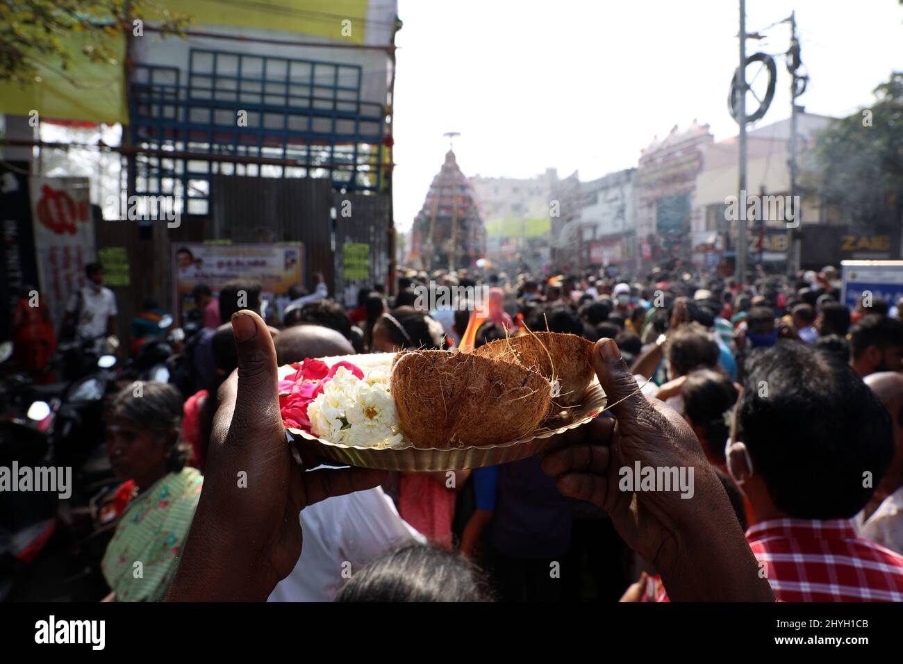 Chennai, Tamil Nadu, India. 15th Mar, 2022. Hindu devotees offer prayers as a chariot decorated with flowers and statues carrying a diety of Hindu God Shiva passes by during an annual temple car festival procession in Chennai. (Credit Image: © Sri Loganathan/ZUMA Press Wire) Stock Photo