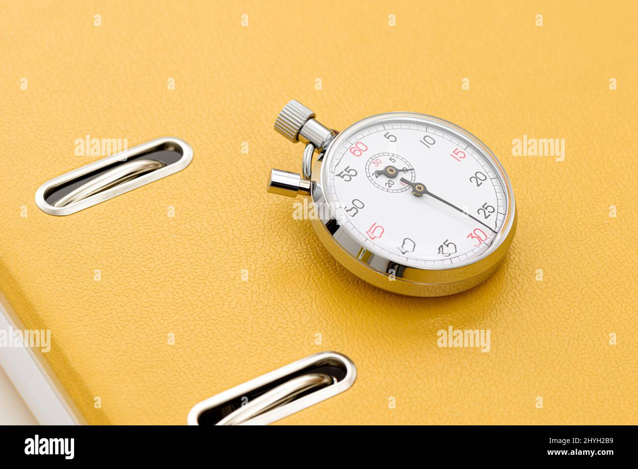 Yellow office folder on the chronometer. Stock Photo