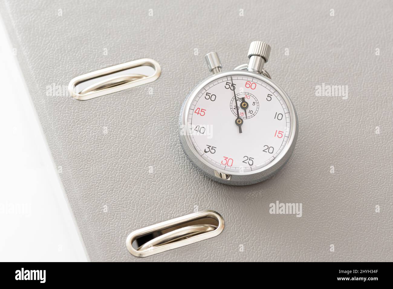 Yellow office folder on the chronometer. Stock Photo
