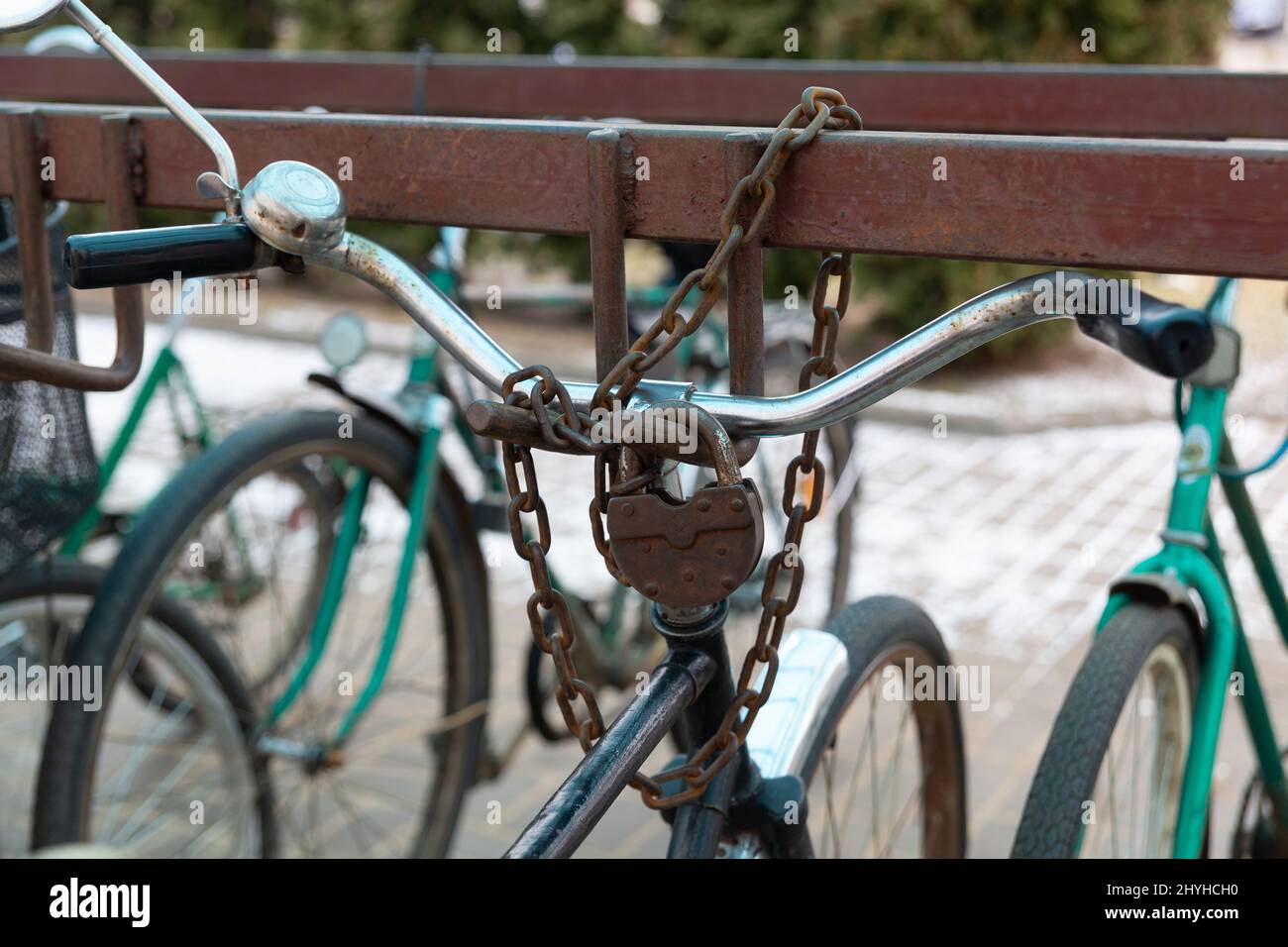 Bicycle chained to a parking. Lock and chain on bicycle handlebar