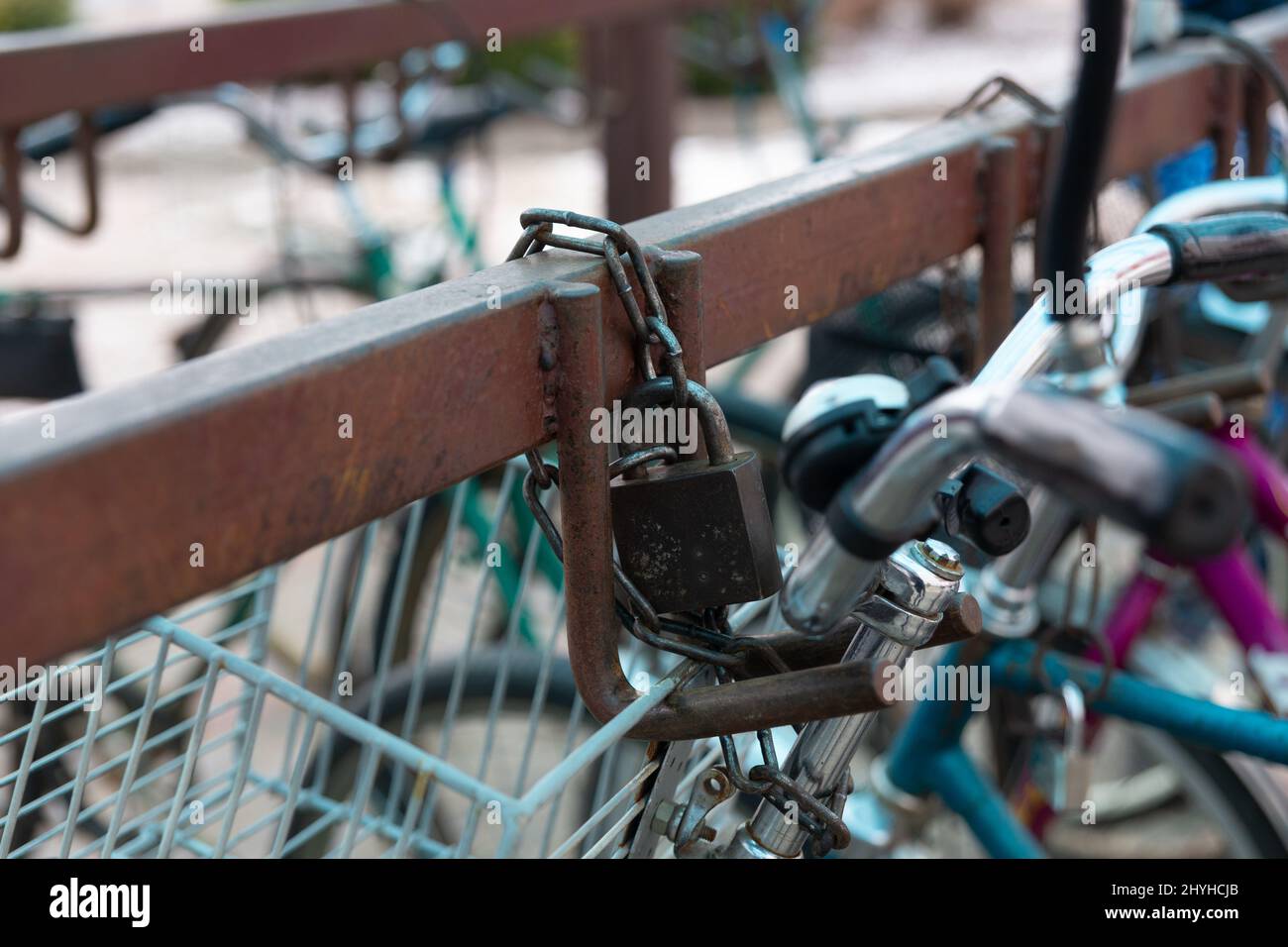 Bicycle chained to a parking. Lock and chain on bicycle handlebar