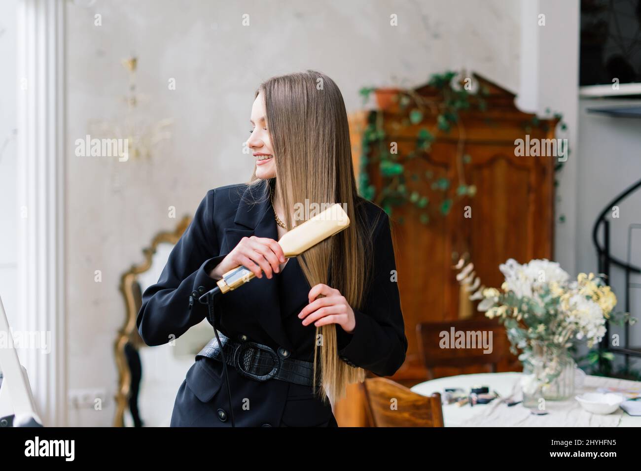 Oil hair treatment for a woman, female takes care of her hair, comb