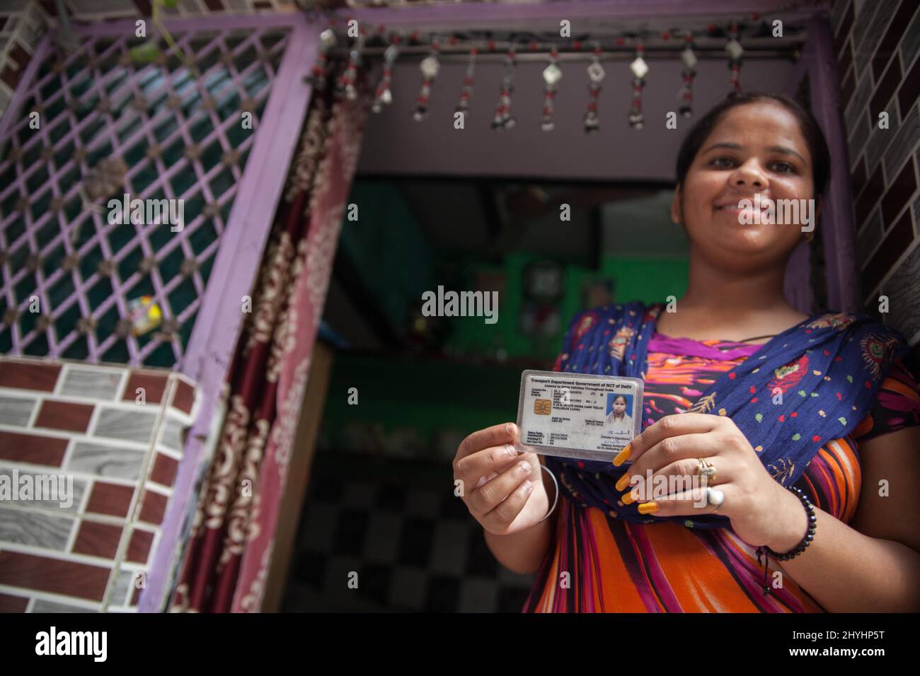 Delhi, India. 02nd Oct, 2016. A woman holds up her taxi driving license outside her home in Delhi. Azad Foundation in Delhi offers training for women of vulnerable backgrounds who want to become taxi drivers. (Photo by Ana Norman Bermudez/SOPA Images/Sipa USA) Credit: Sipa USA/Alamy Live News Stock Photo