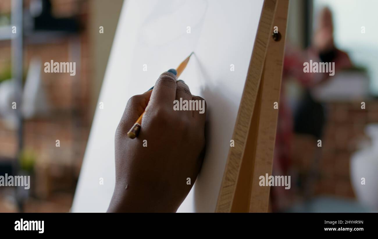 Creative woman using pencil to draw vase model in art class on canvas ...