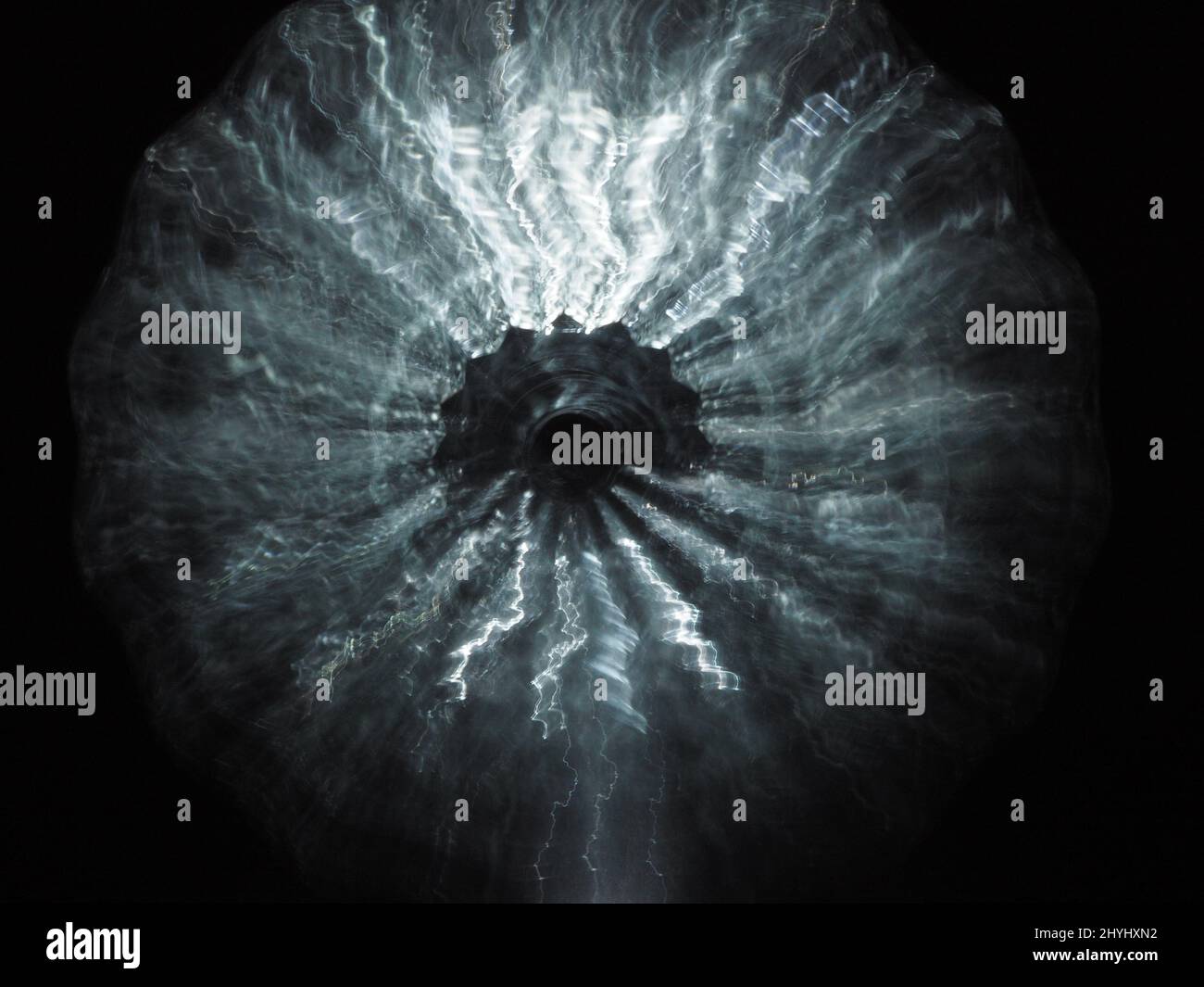 Blurry abstract silver star exploding in the darkness. Silver abstract background Stock Photo