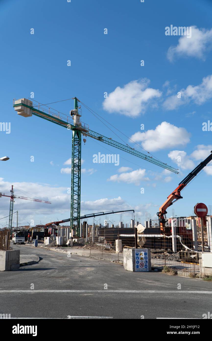 Vertical shot of a construction site with a Caucasian worker in Spain ...