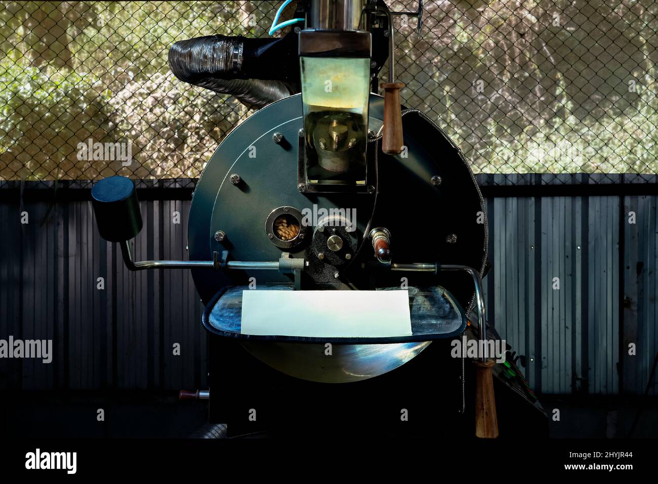 Freshly roasted coffee beans in the coffee roaster machine. Small