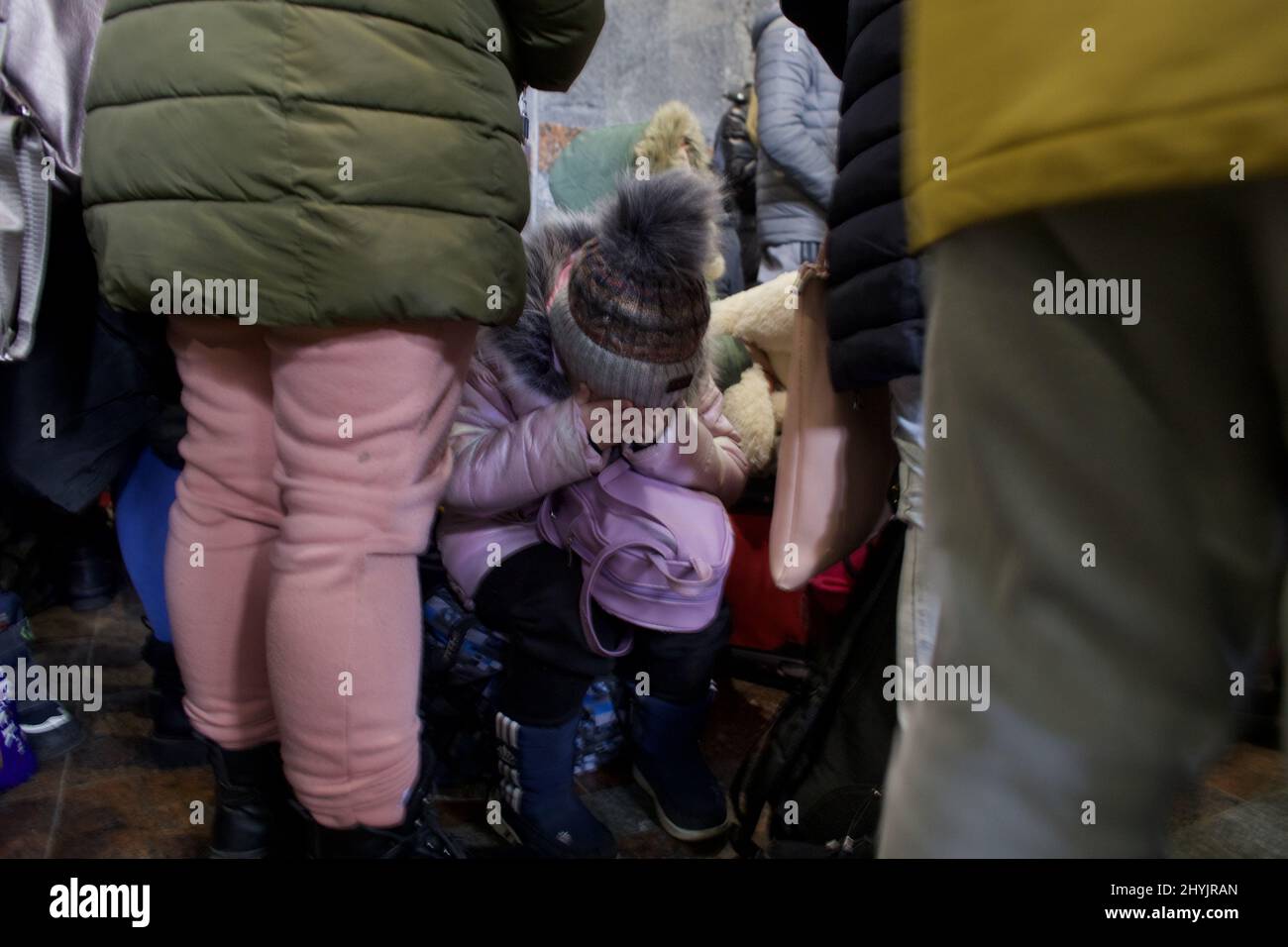 2022-03-04 10:52:44 Lviv, Ukraine. A little girl sits between the grown ...