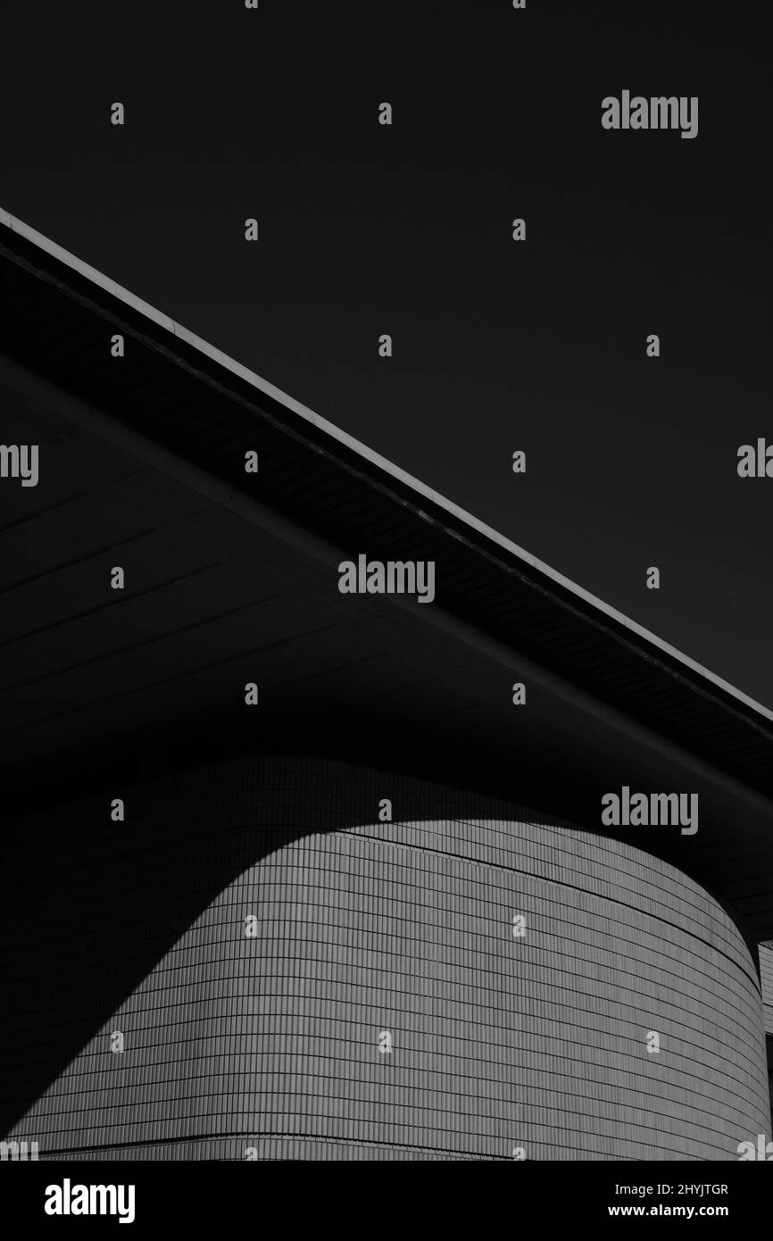 Vertical grayscale shot of a modern building with the moonlight Stock ...