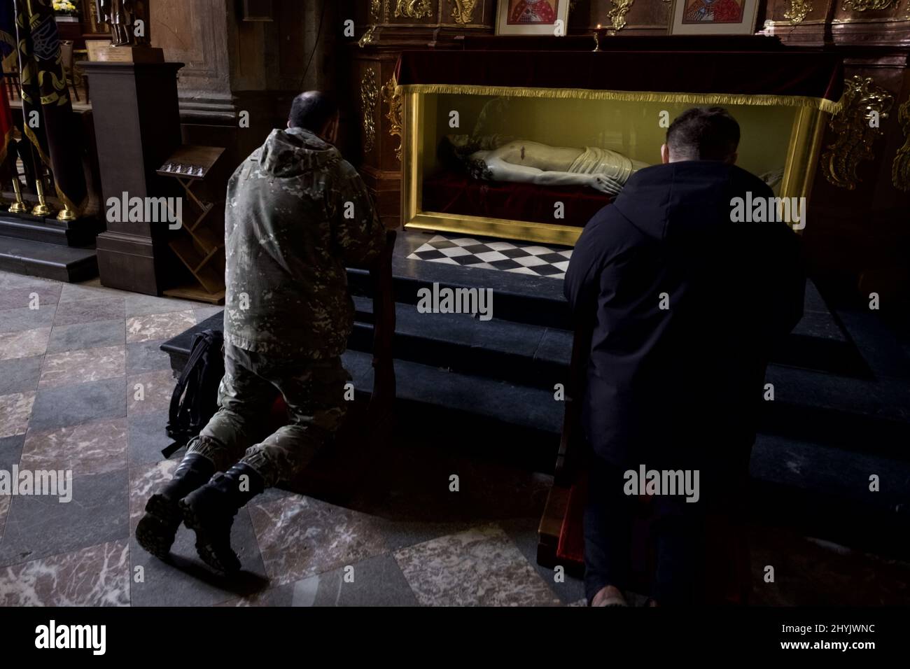 Lviv, Ukraine. A soldier Nielsen prays in front of a coffin that depicts Jesus Christ in the military church in central Lviv. ANP / Hollandse Hoogte / Warren Richardson Stock Photo