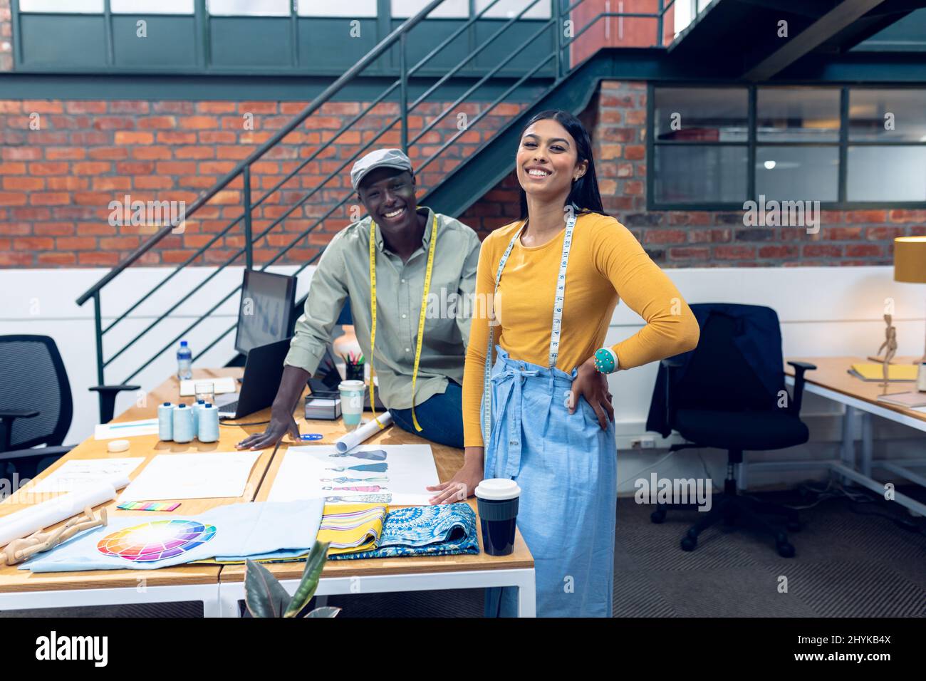Male and female fashion designers at work in a bright studio Stock ...