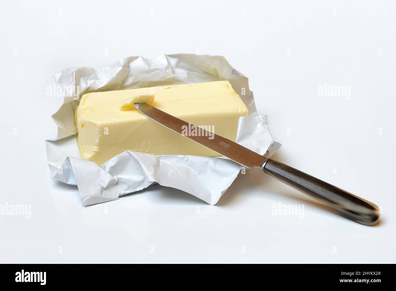 Butter with opened package and knife Stock Photo Alamy