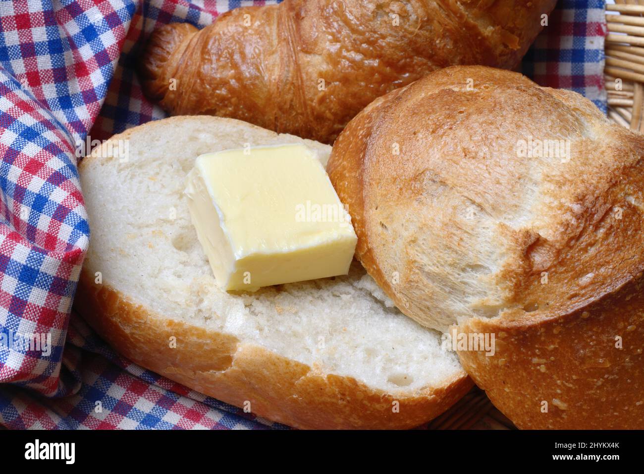 A piece of butter on a roll, bread topping Stock Photo
