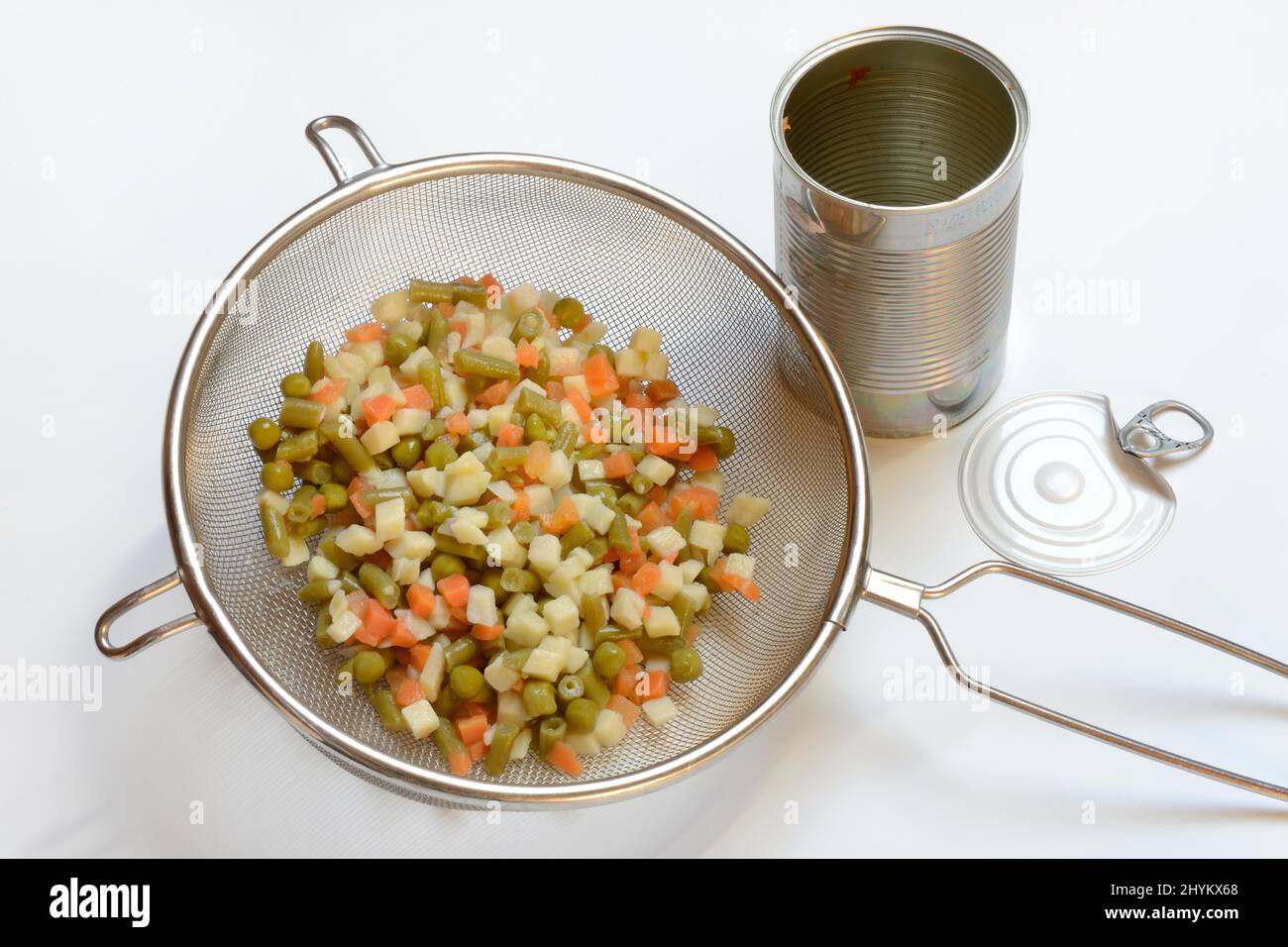 Russian salad in kitchen strainer and tin can, vegetable mix Stock Photo Alamy