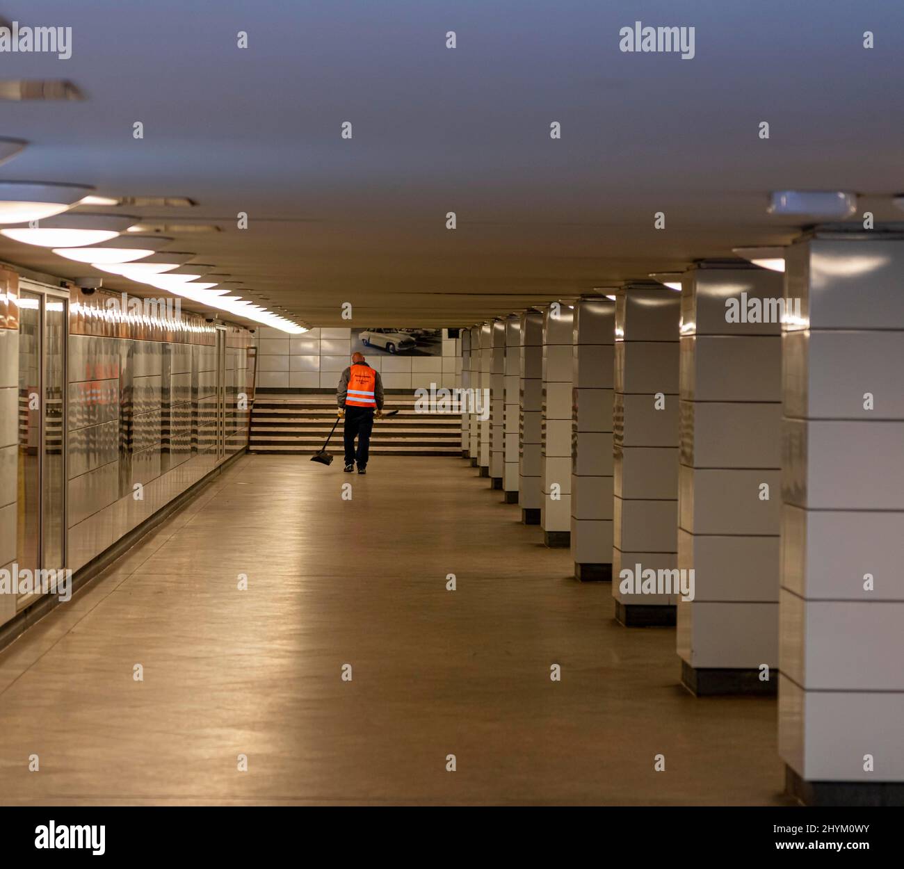 Man cleaning U train station Schillingstrasse, Berlin, Germany Stock