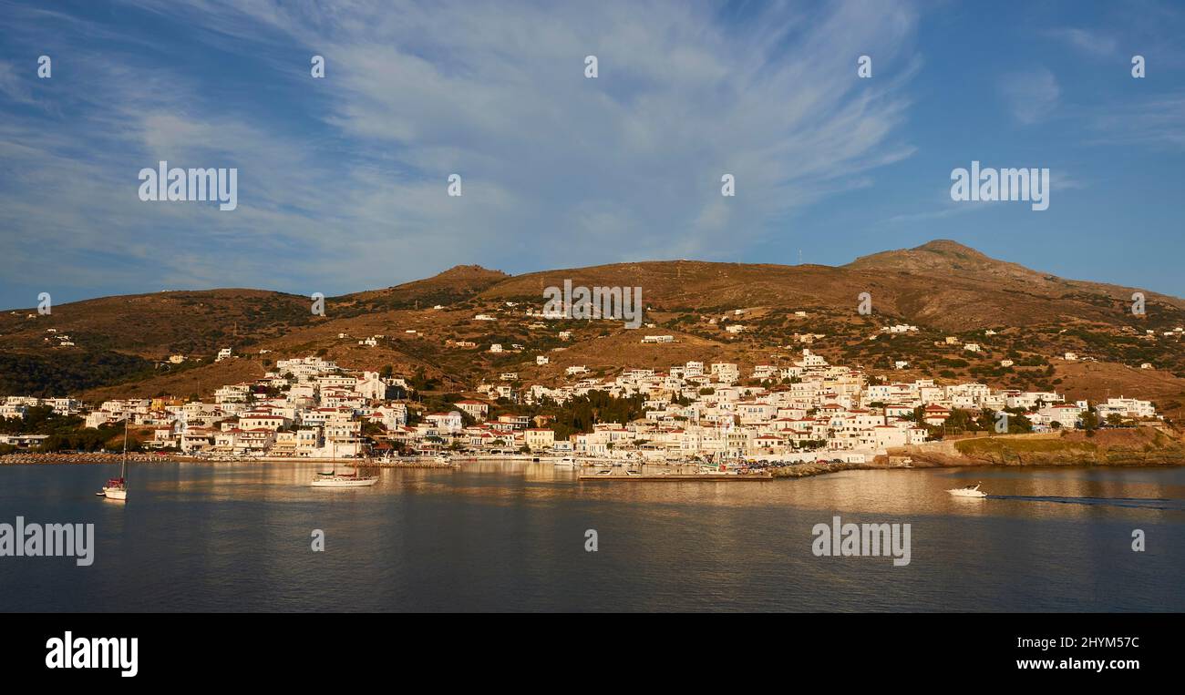 Panorama, Picturesque harbour village Batsi, Soft evening light, Sailboat, Motorboat small, Harbour, Houses on the slope, Hills in the background Stock Photo
