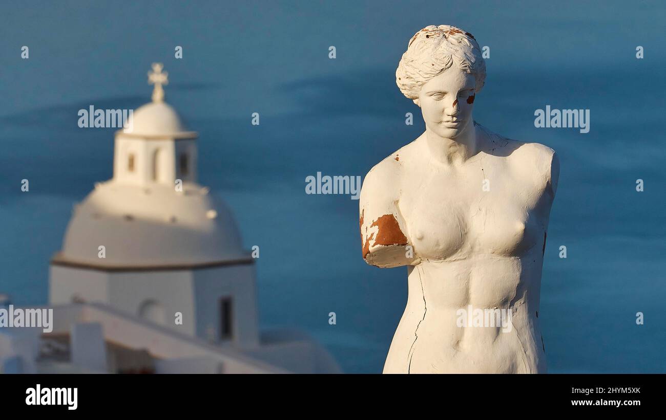 Morning light, plaster bust of a woman, white dome of a church behind, sea dark blue, Fira, Santorini Island, Cyclades, Greece Stock Photo