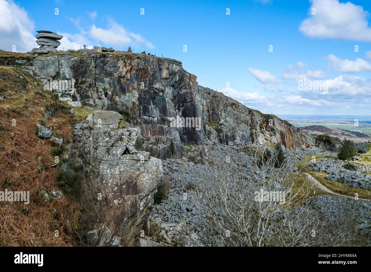 The Cheesewring rock stack on the edge of the remains of the disused Stowes Hill Quarry Cheesewring Quarry on Bodmin Moor in Cornwall. Stock Photo