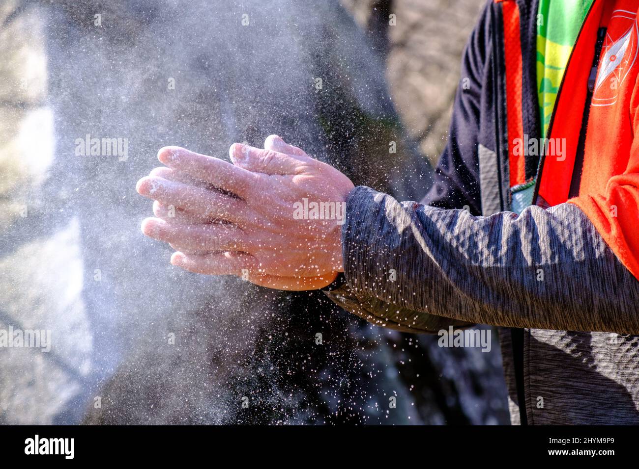 Preparing for bouldering. Chalk on the hands Stock Photo