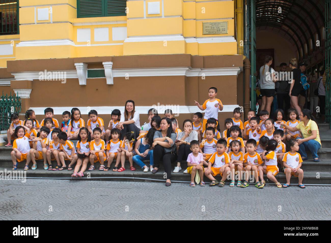 Kindergarten children in front of the main post office, Saigon, Vietnam Stock Photo