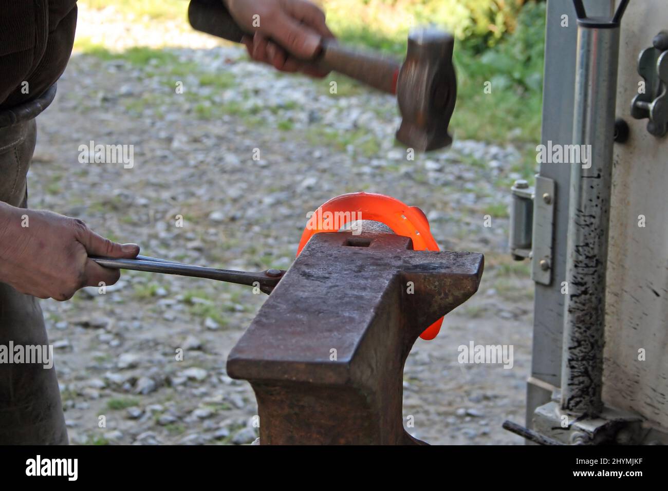 Blacksmith a redhot iron in the Stock Photo Alamy