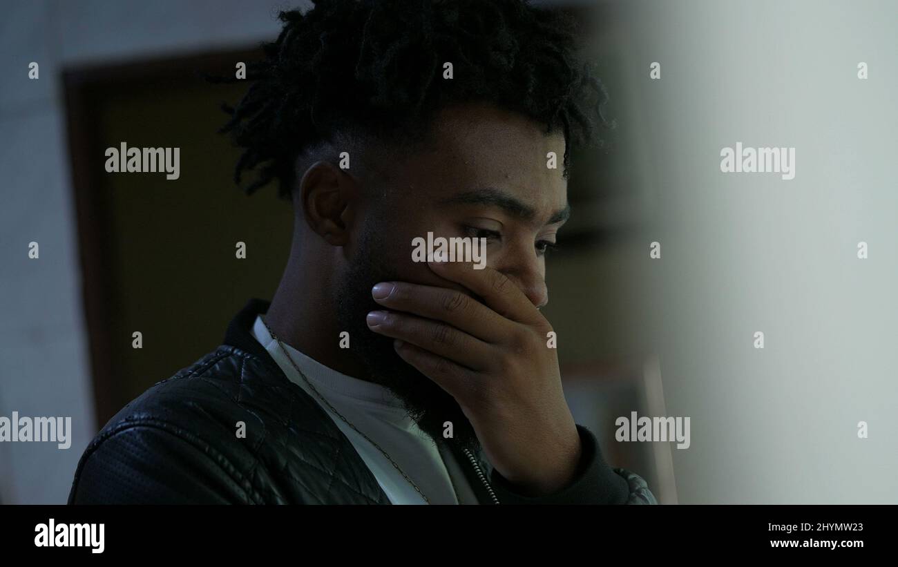A pensive black man thinking a thoughtful African person contemplating ...