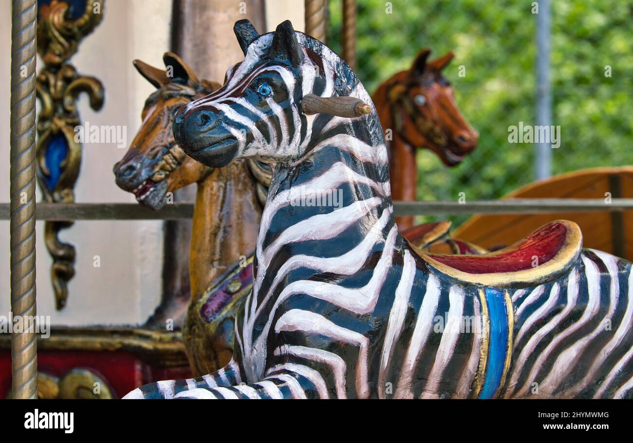 Children's carousel, one zebra figure and two horse figures, Feldbach, Switzerland Stock Photo
