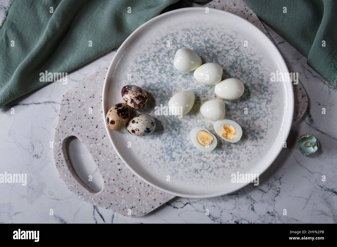 Boiled eggs lying on a plate, on a board. Useful and tasty ingredient. Stock Photo