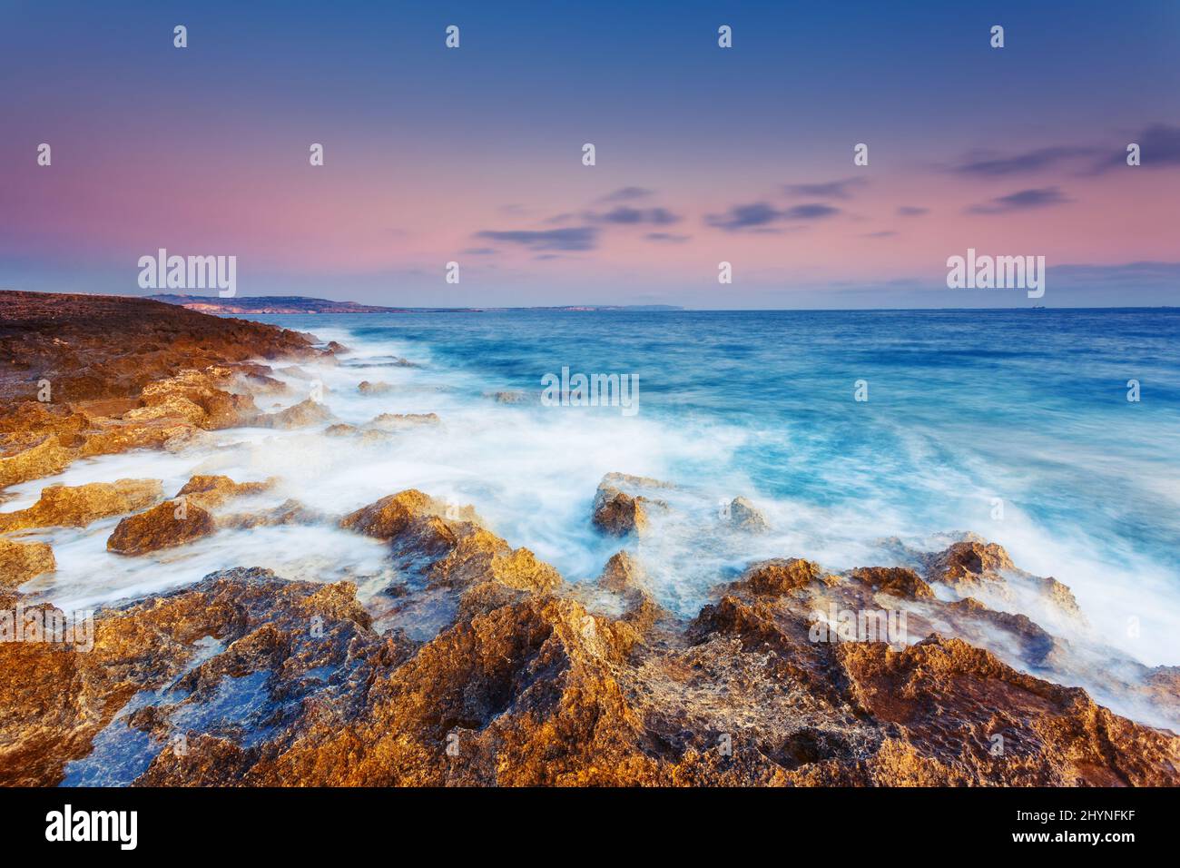 Amazing morning sun over the sea. Volcanic island of Malta. Qawra