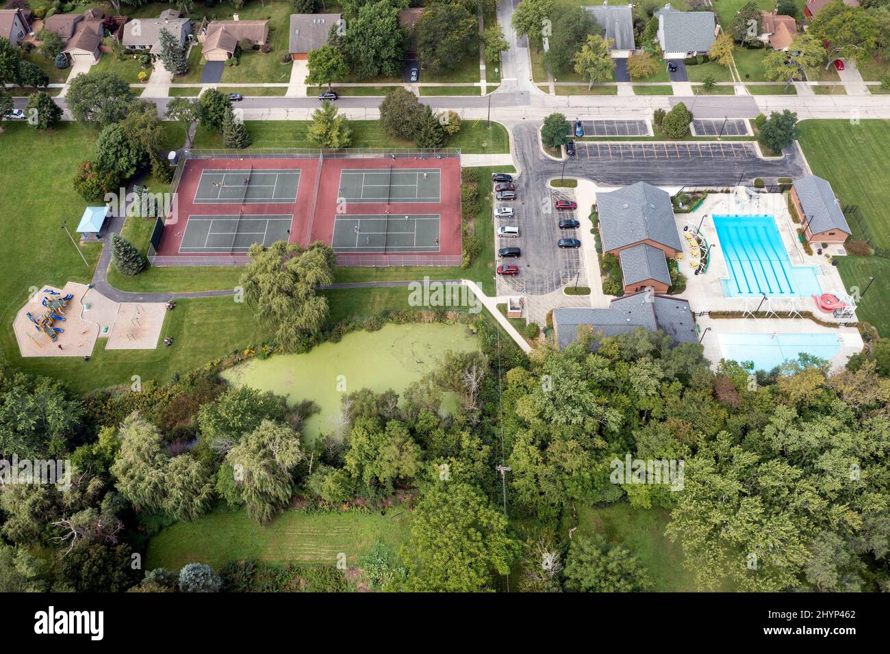 Aerial view of a suburban park district playground with tennis courts