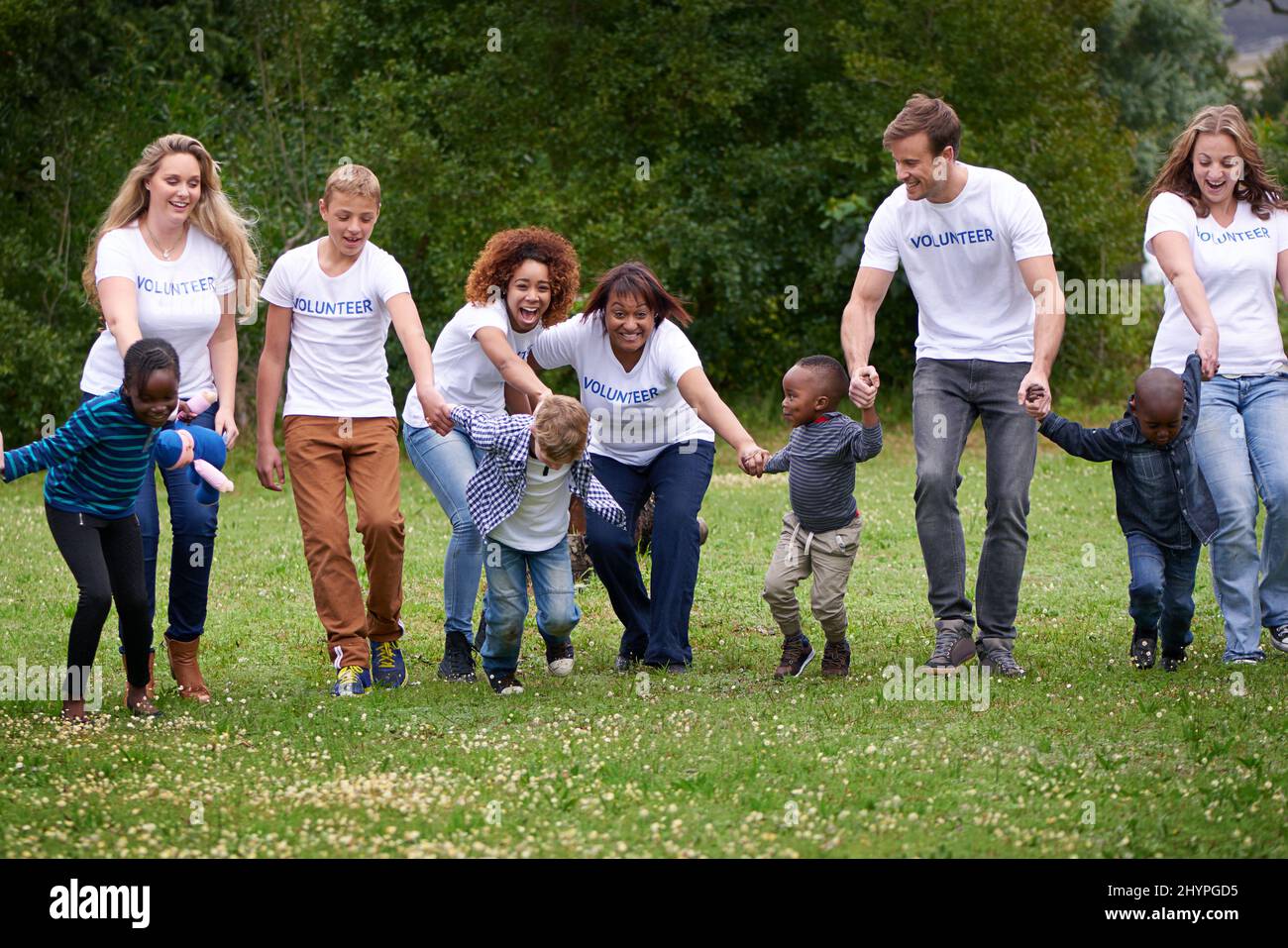 Work for a cause, not applause. Shot of volunteers working with little children. Stock Photo