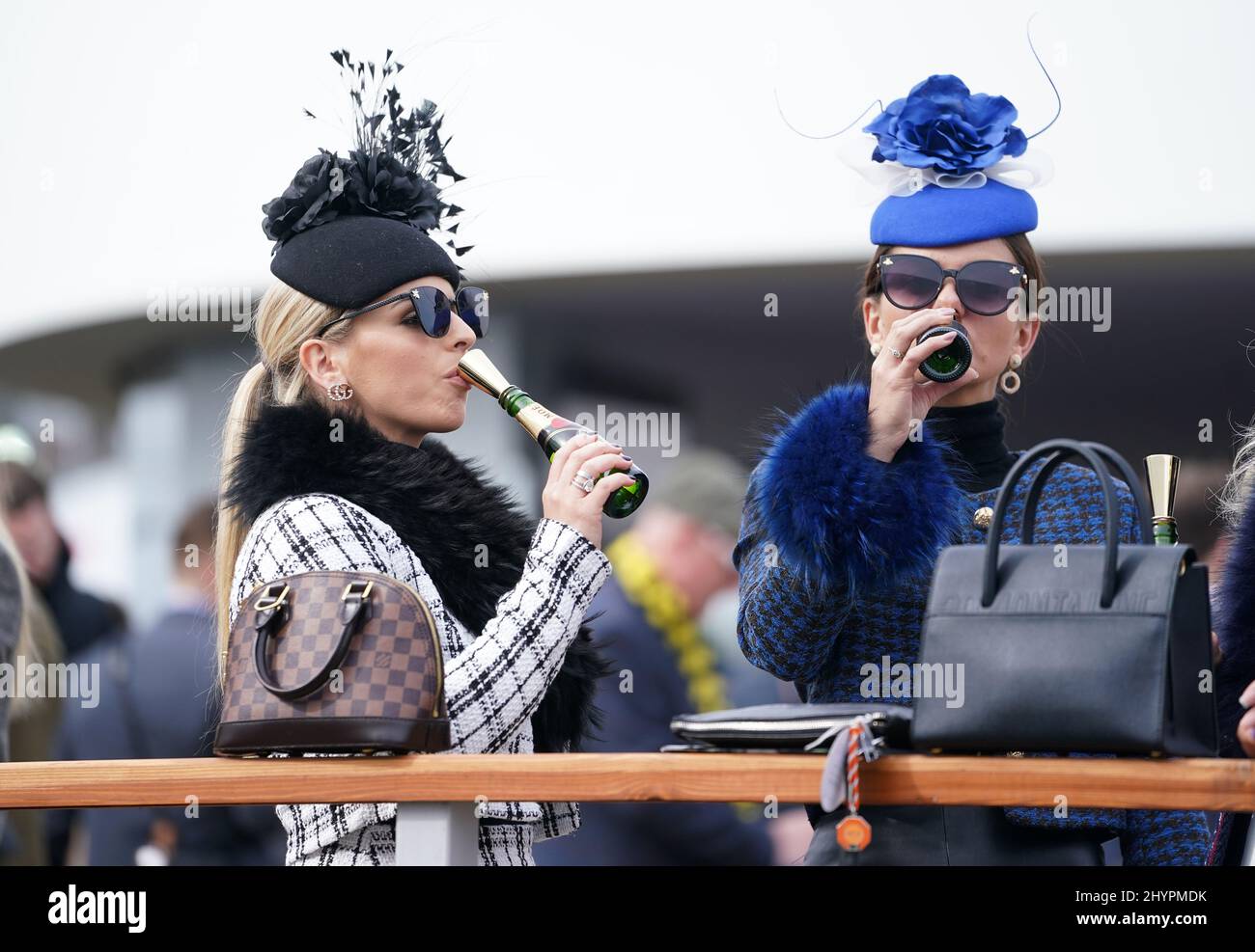 A racegoer enjoy a drink during day one of the Cheltenham Festival at ...