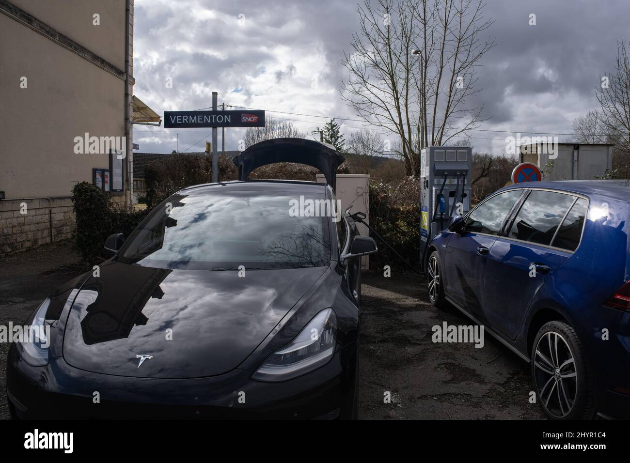 Vermenton, France - February 23 , 2022: A static shot of a solid black Tesla Model 3 dual motor long range awd charging at the DC Freshmile charging s Stock Photo