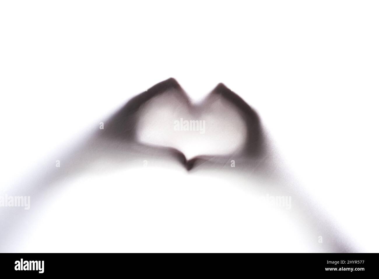 The symbol of love. Cropped shot of an unrecognizable persons hands making a heart sign. Stock Photo