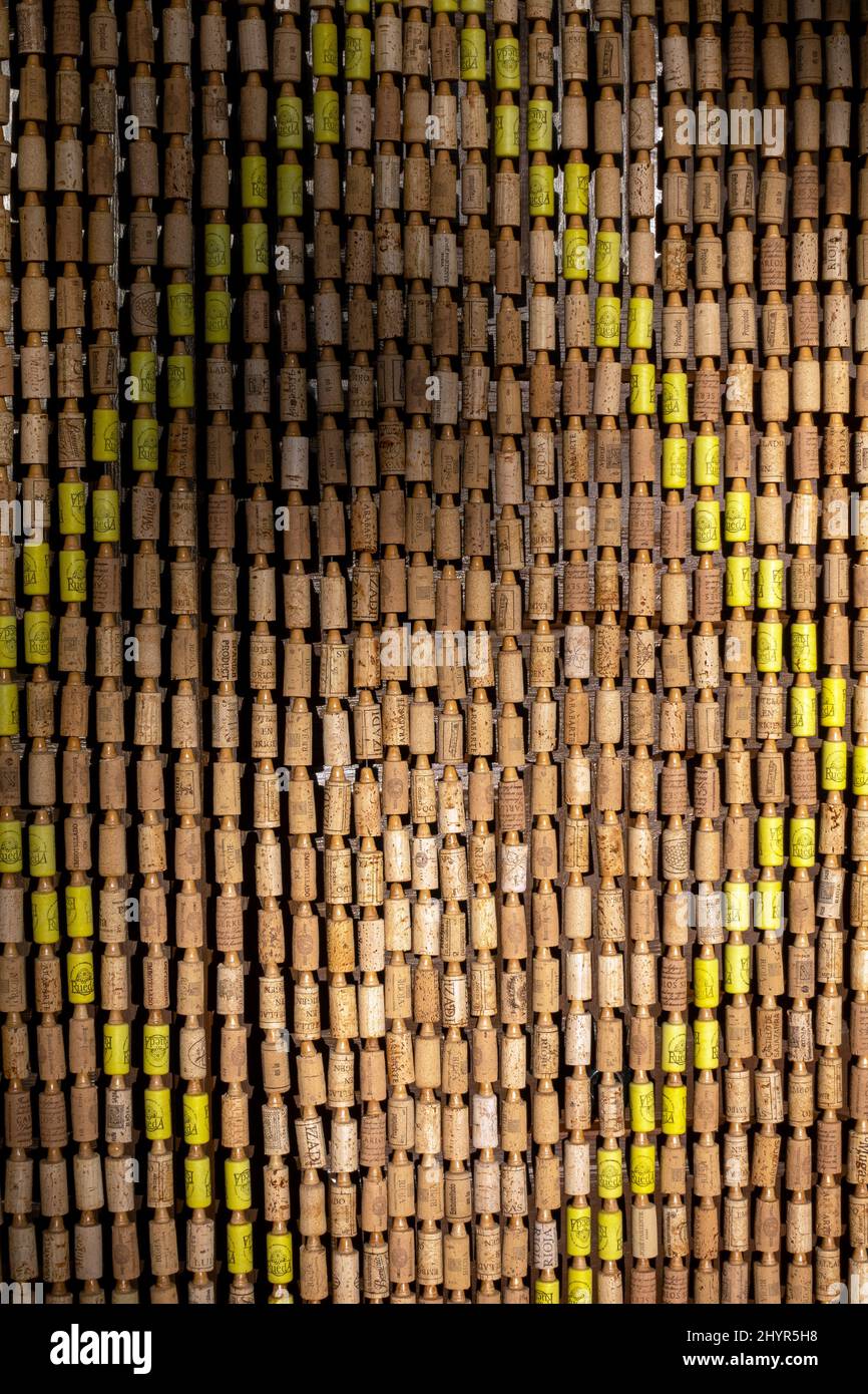 Traditional door curtain on Spanish house made from wine bottle corks to help keep flies out and to provide shade Stock Photo