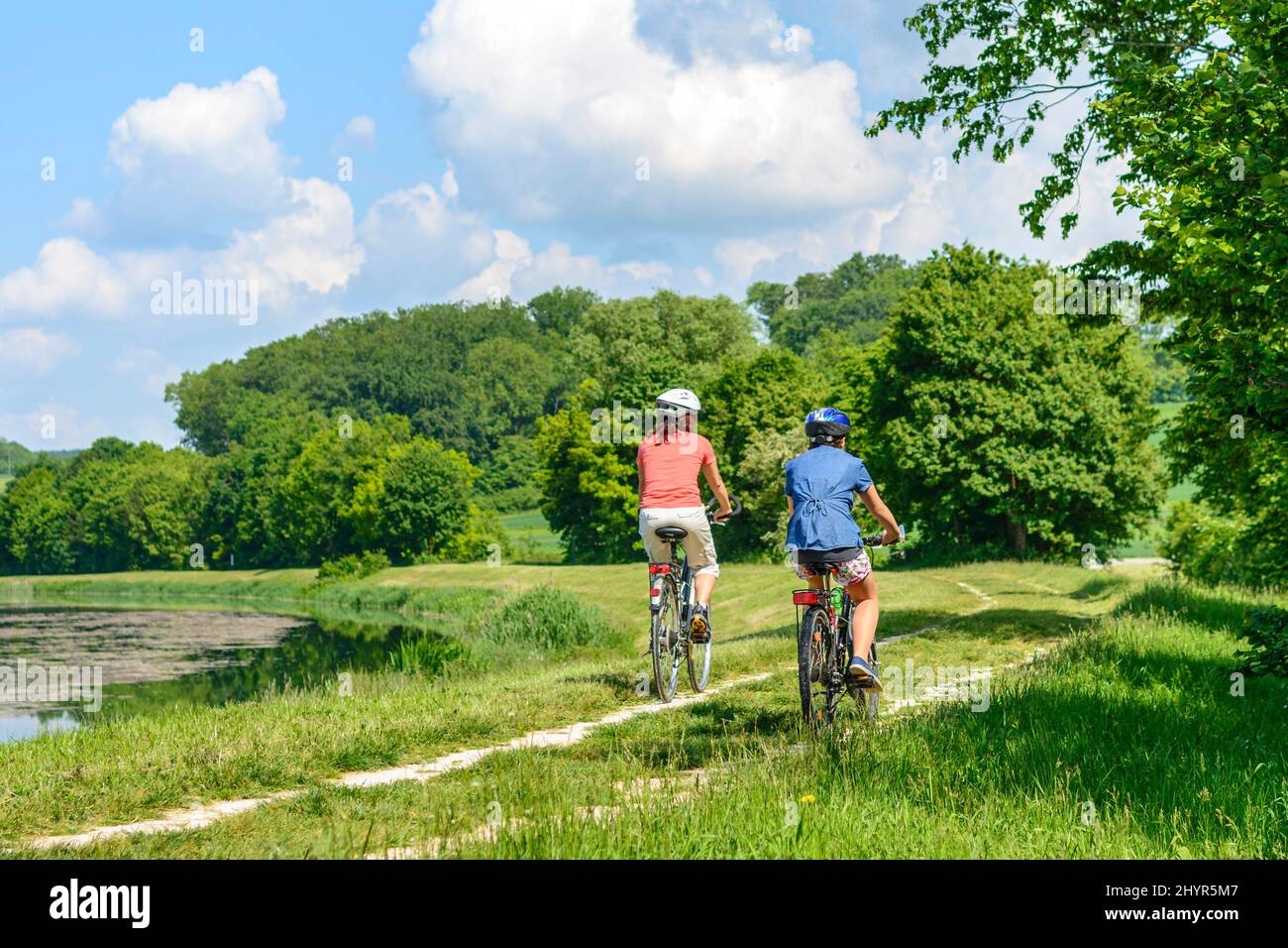 Mother with daughter doing a cycling tour in beautiful nature in southern germany Stock Photo